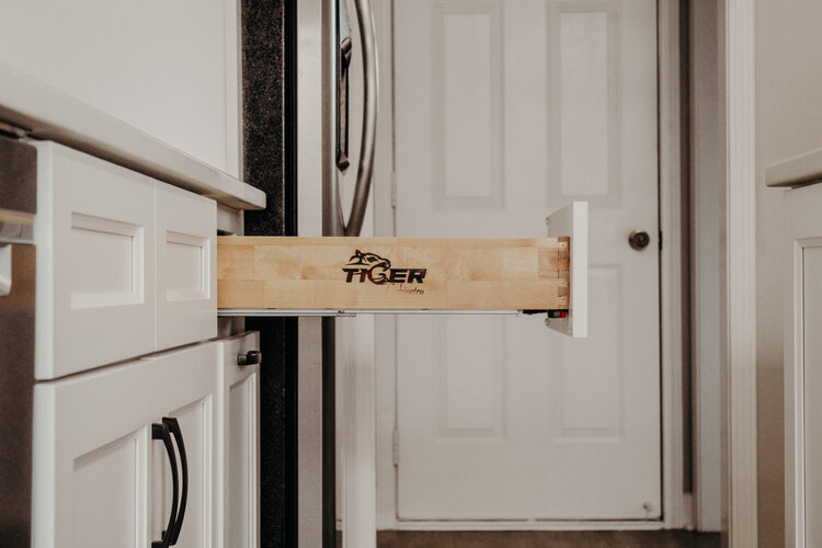 A maple drawer box on full extension soft-close runners, branded on the side panel